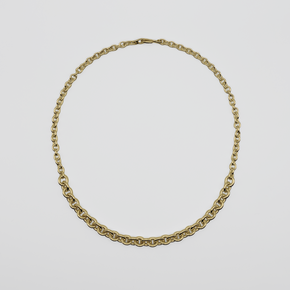 Gold chain necklace on a light gray background