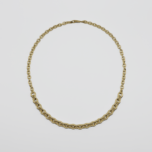 Gold chain necklace on a light gray background