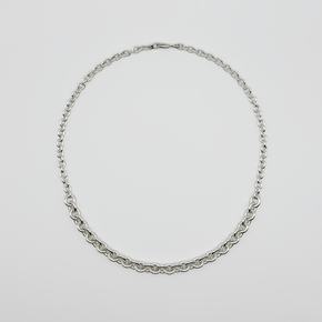 Silver chain necklace on a light gray background