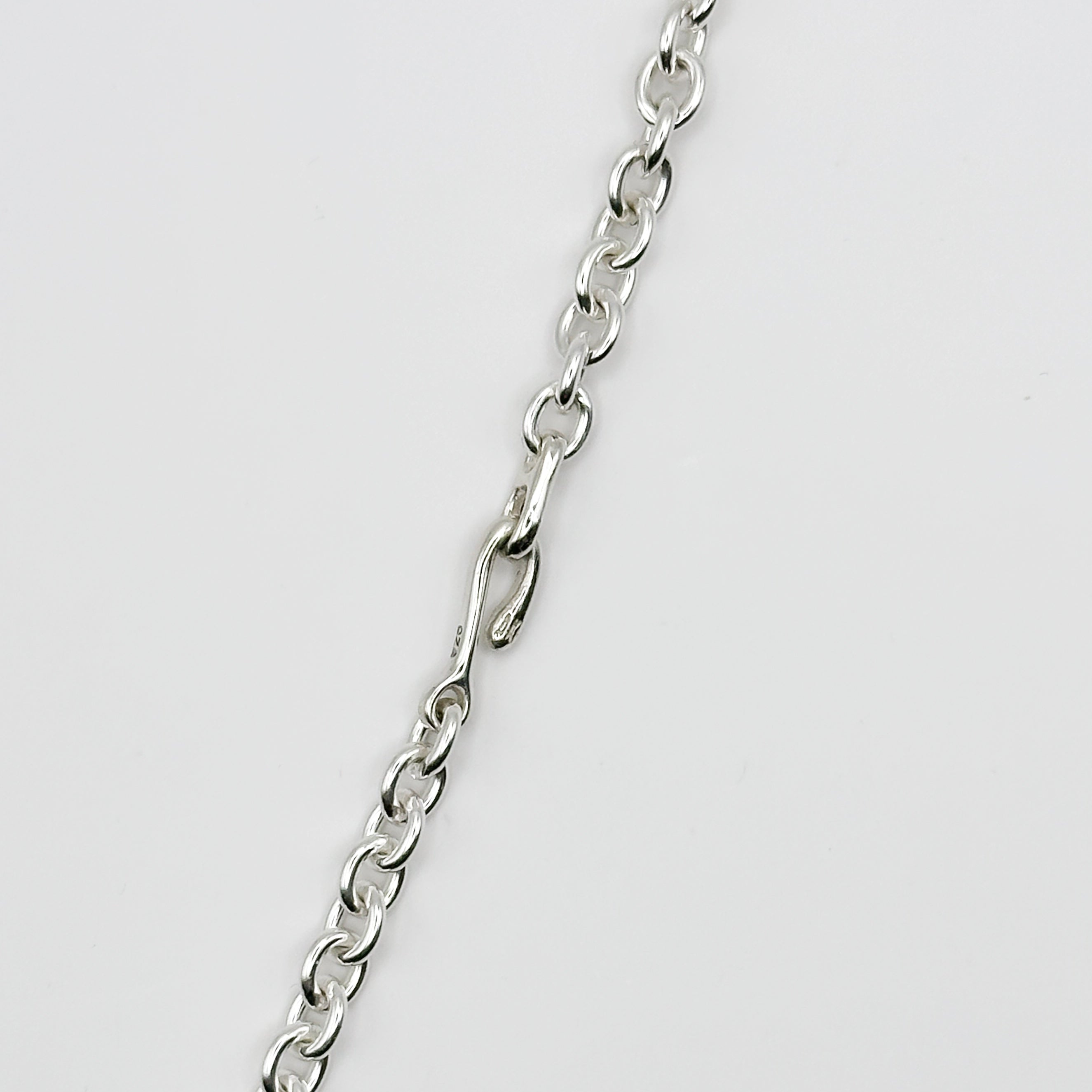 Silver chain on a light gray background