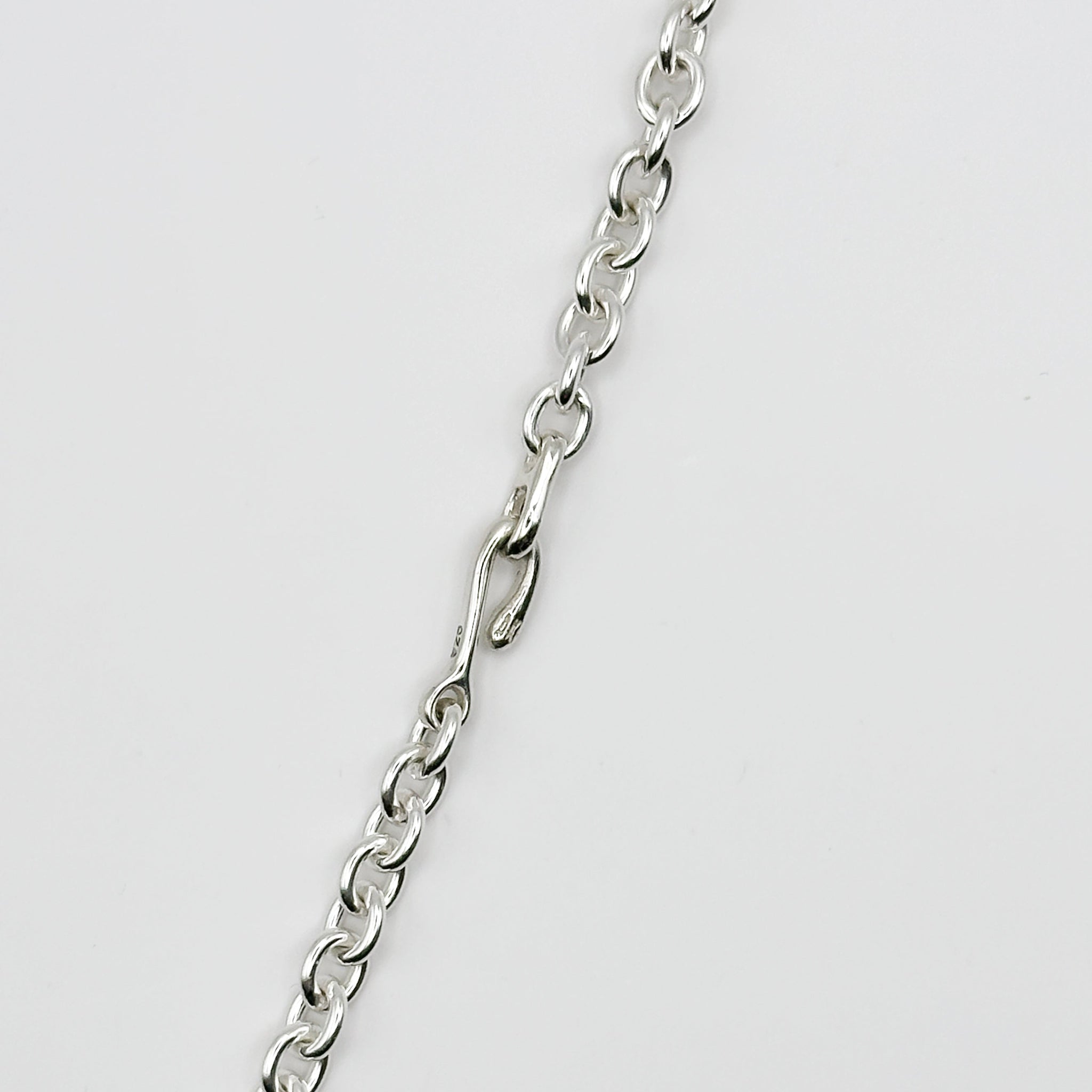 Silver chain on a light gray background