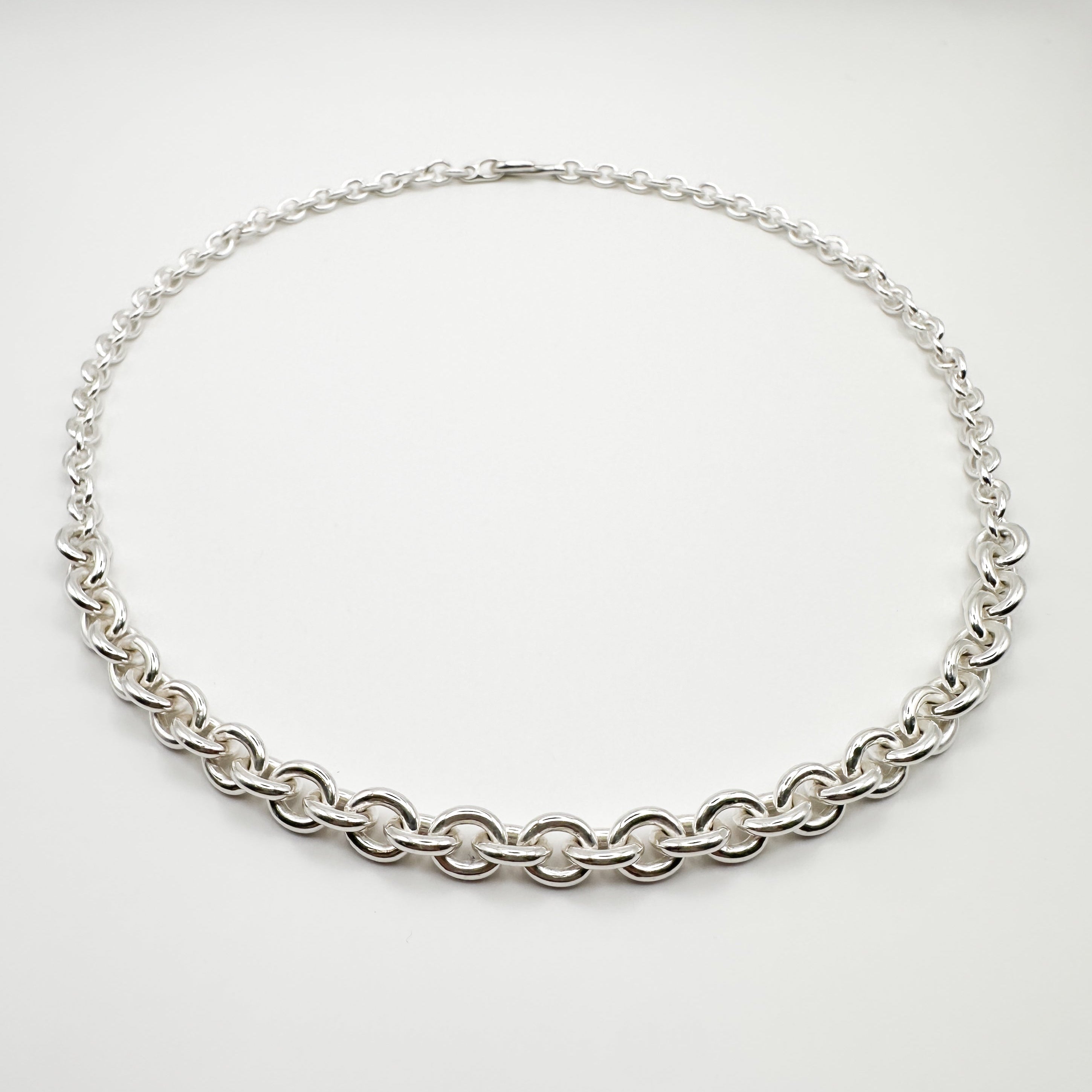 Silver chain necklace on a white background