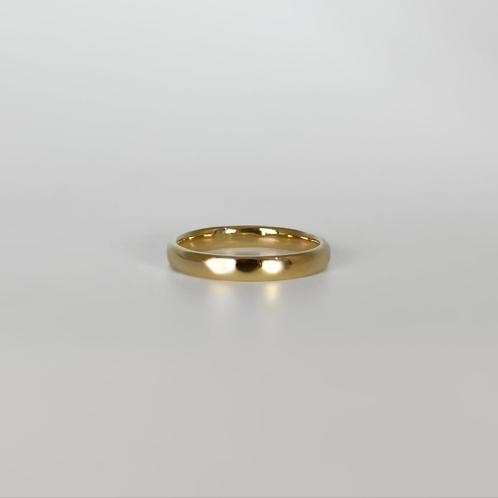 Gold ring on a light gray background