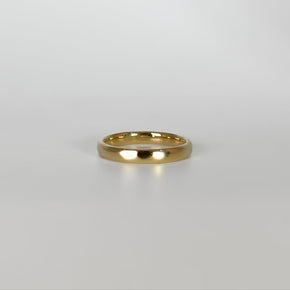 Gold ring on a light gray background