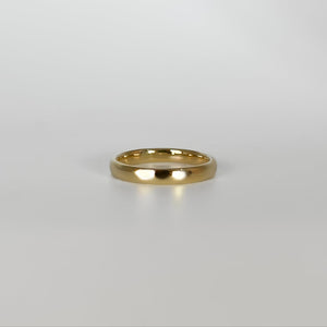 Gold ring on a light gray background