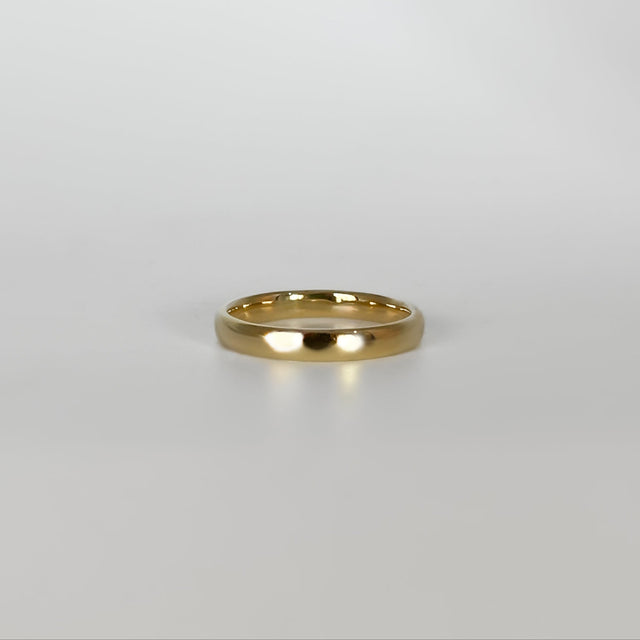 Gold ring on a light gray background