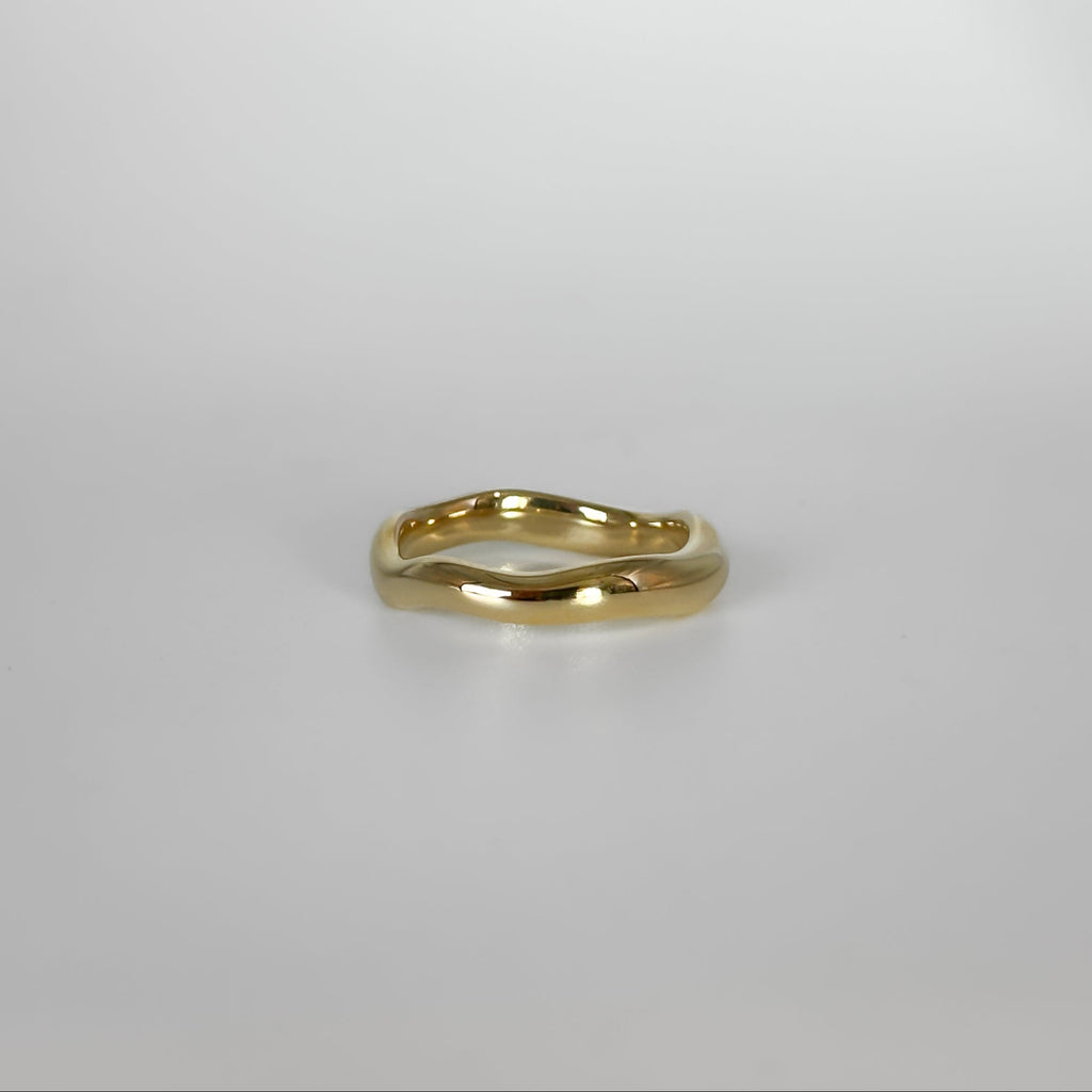 Gold ring on a light gray background