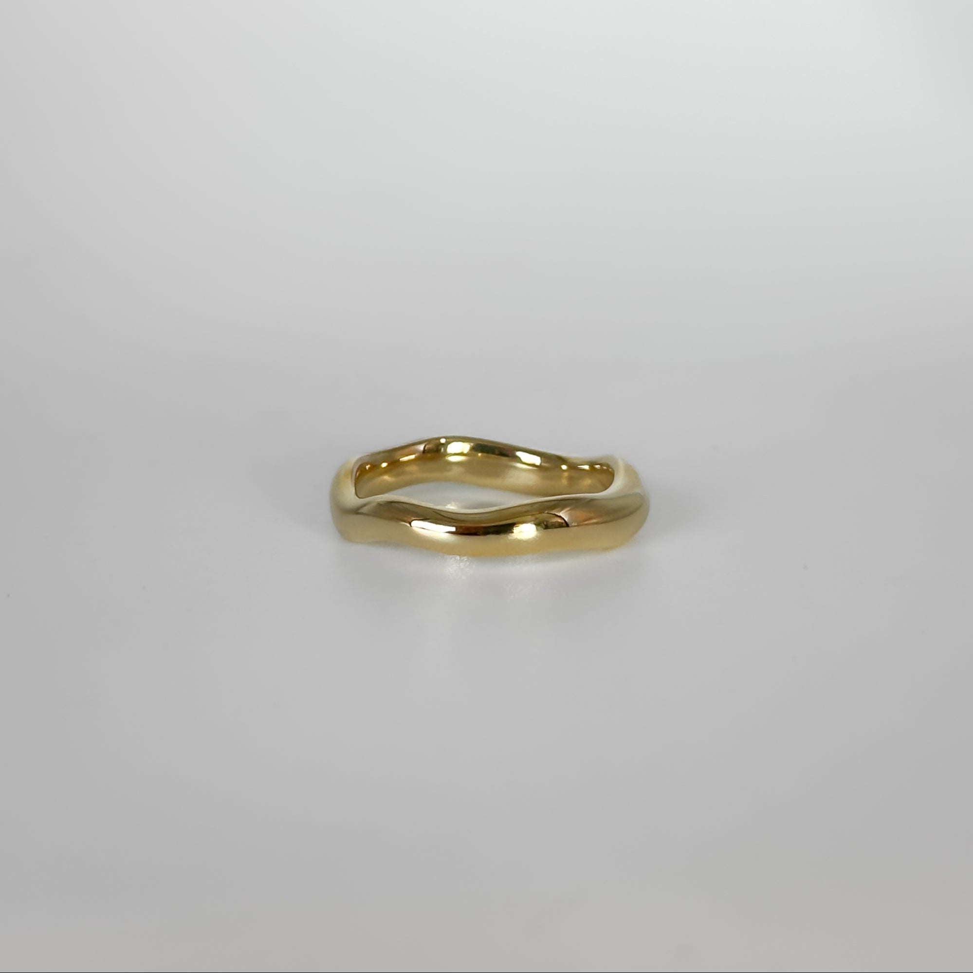 Gold ring on a light gray background