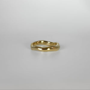 Gold ring on a light gray background