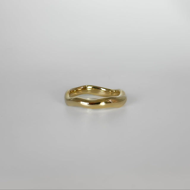 Gold ring on a light gray background