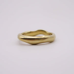 Gold ring on a light gray background