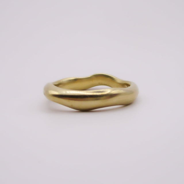 Gold ring on a light gray background