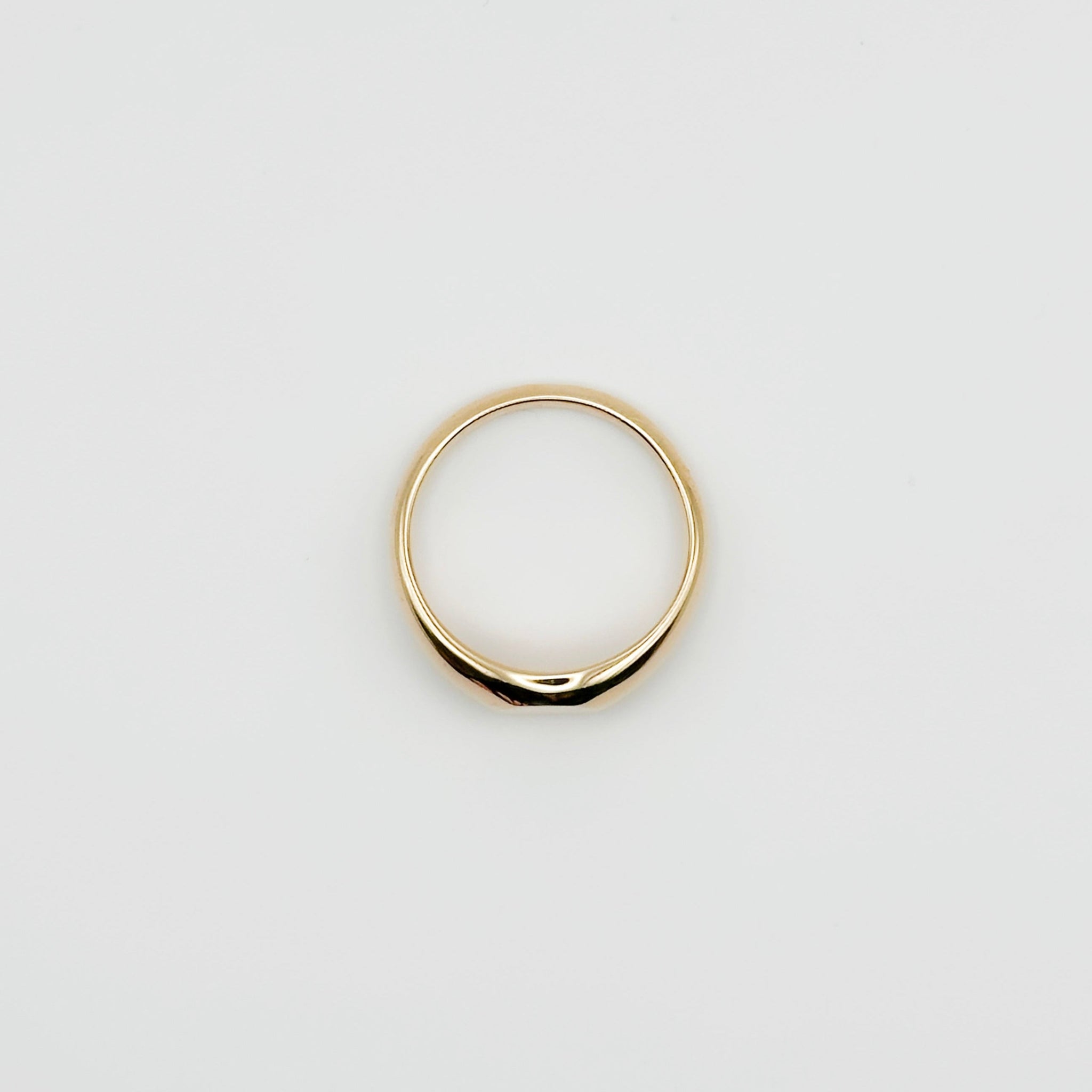 Gold ring on a light gray background