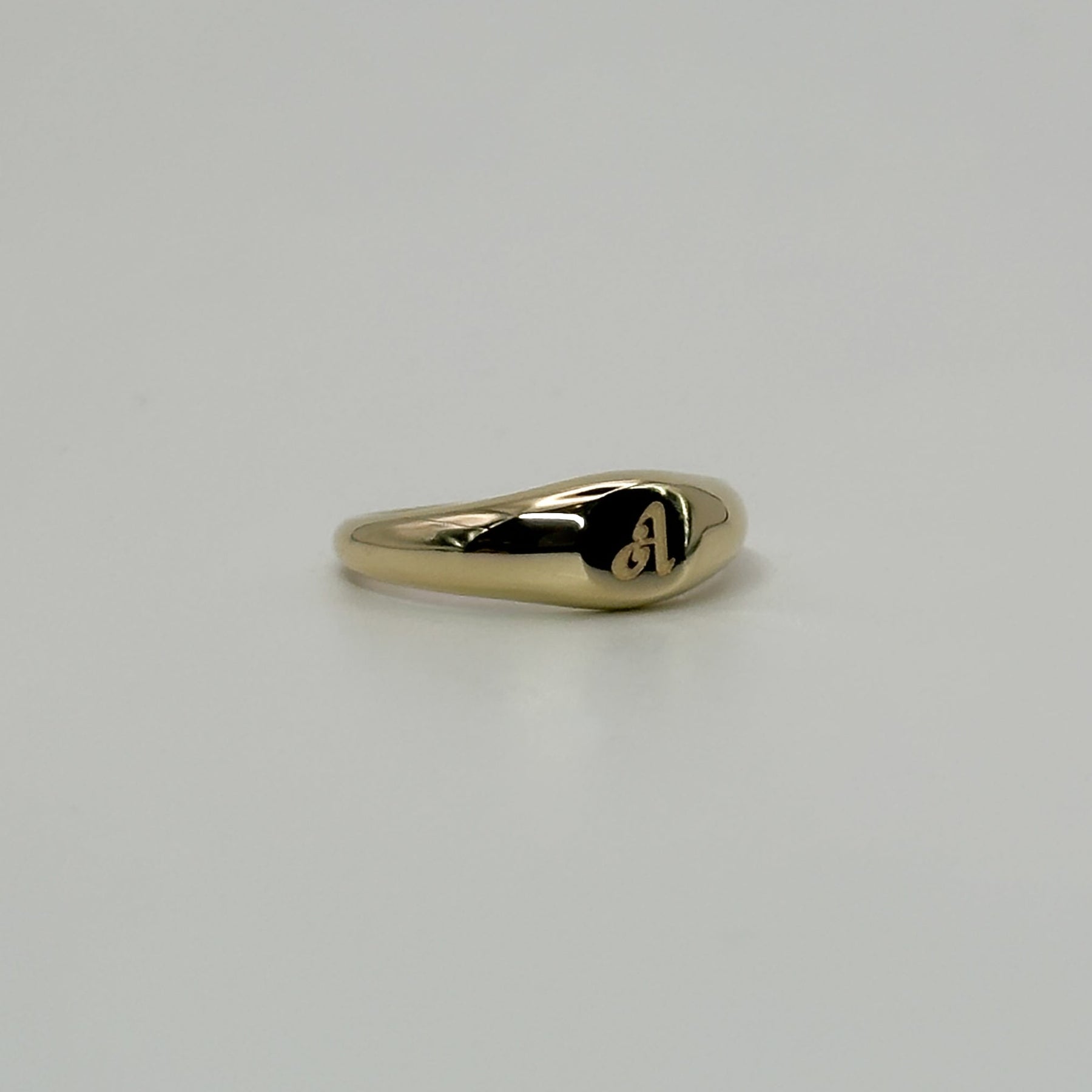 Gold ring on a light gray background