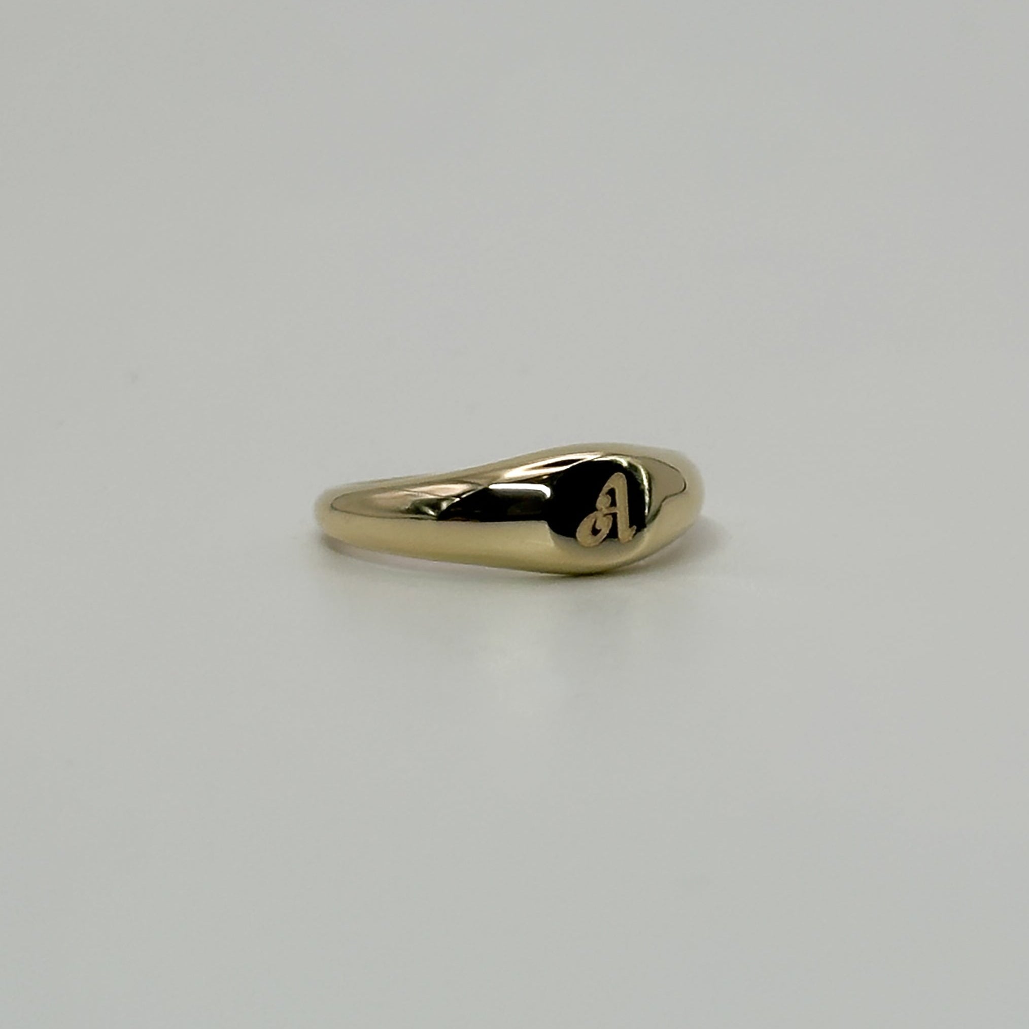 Gold ring on a light gray background