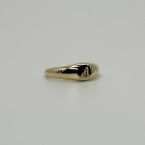 Gold ring on a light gray background