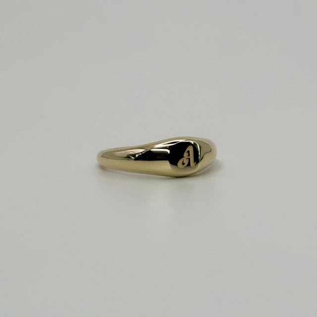 Gold ring on a light gray background