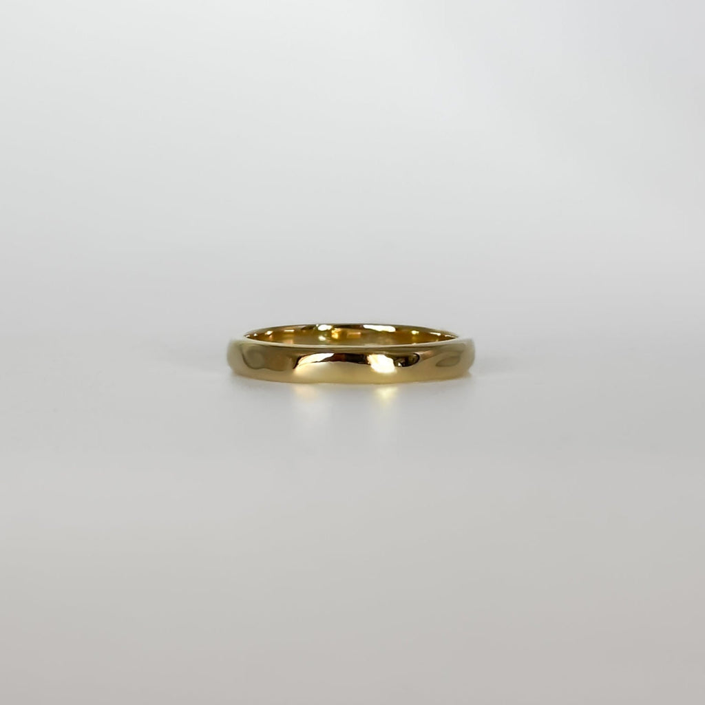 Gold ring on a light gray background