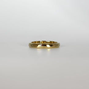 Gold ring on a light gray background