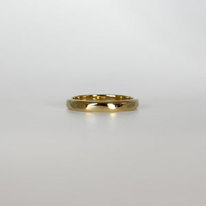 Gold ring on a light gray background