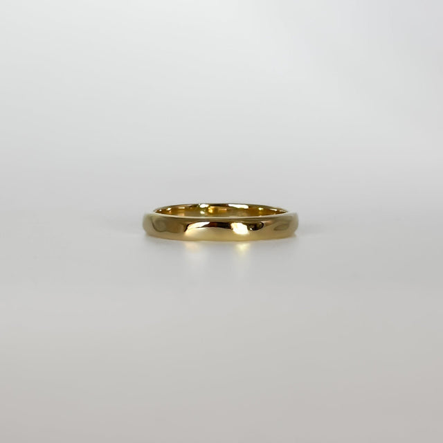 Gold ring on a light gray background