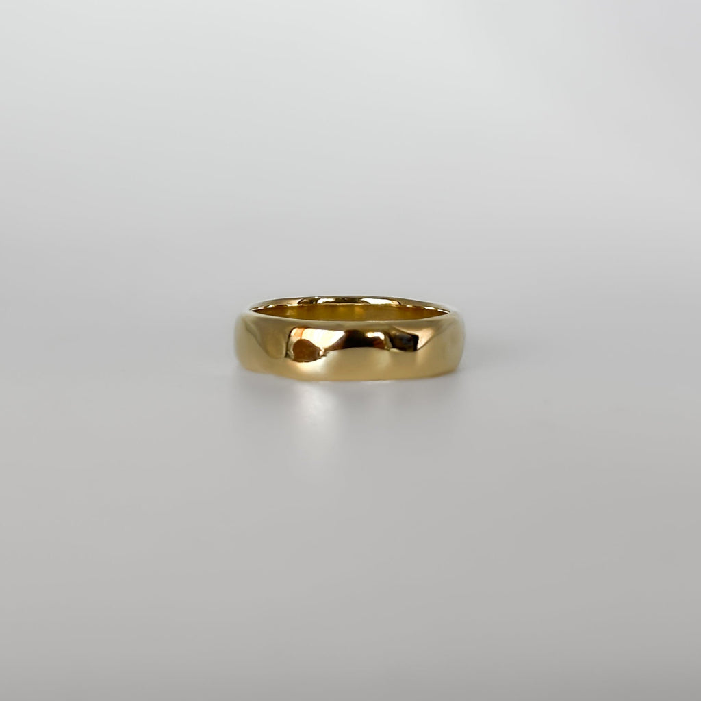 Gold ring on a light gray background