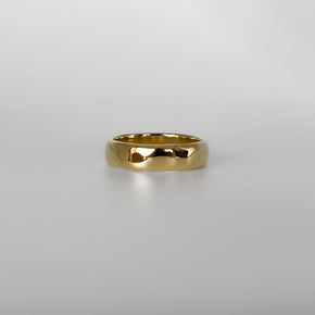 Gold ring on a light gray background