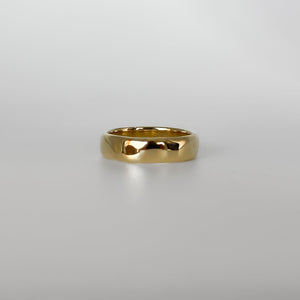 Gold ring on a light gray background