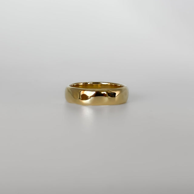 Gold ring on a light gray background