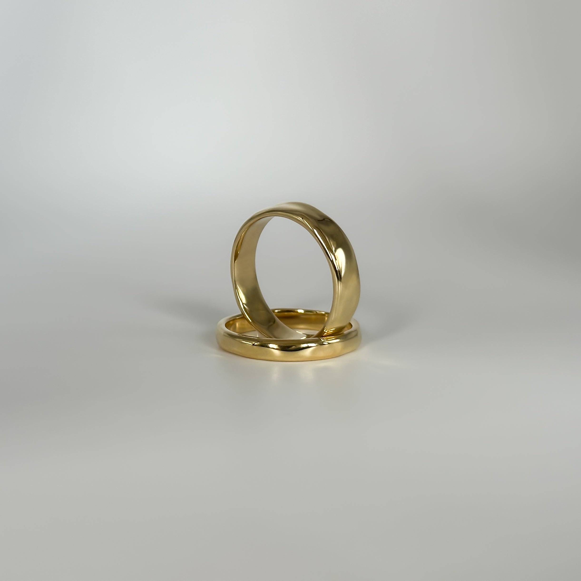 Gold ring on a light gray background