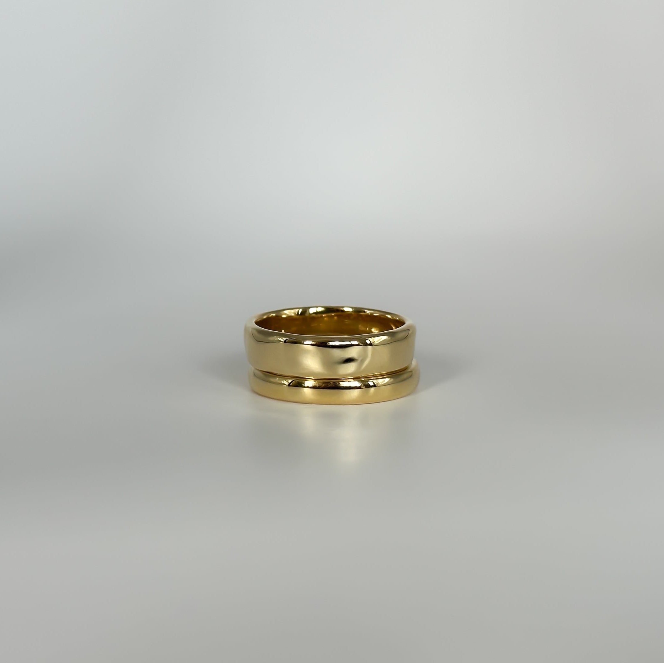 Gold rings on a light gray background