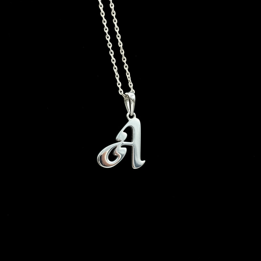 A silver pendant in the shape of the letter 'A' with a chain, against a black background.
