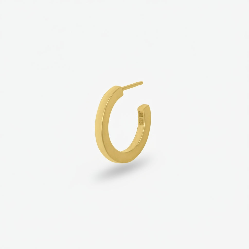 Gold hoop earring on a white background